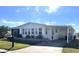 Inviting single-story home with a long carport and manicured landscaping at 346 Mariner Dr, North Port, FL 34287