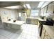 Bright kitchen featuring white tile flooring, appliances and ample countertop space at 346 Mariner Dr, North Port, FL 34287