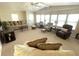 Comfortable living room with ample seating and natural light from large windows at 346 Mariner Dr, North Port, FL 34287