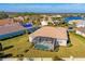 Aerial view of a backyard featuring a screened-in pool, lush green grass, and beautiful community homes at 357 Marsh Creek Rd, Venice, FL 34292
