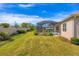 Beautifully landscaped backyard featuring a screened-in pool and patio, perfect for outdoor living and entertainment at 357 Marsh Creek Rd, Venice, FL 34292