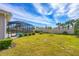 Lush backyard featuring a screened-in pool and patio area with a view of the well manicured lawn at 357 Marsh Creek Rd, Venice, FL 34292