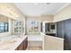Bathroom featuring double sinks, a soaking tub, and a separate shower with glass surround at 357 Marsh Creek Rd, Venice, FL 34292