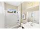 This bathroom features a shower-tub combo and neutral walls with a small window at 357 Marsh Creek Rd, Venice, FL 34292