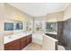 Bathroom featuring double sinks, a soaking tub, and a separate shower with glass surround at 357 Marsh Creek Rd, Venice, FL 34292