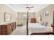 Bright bedroom with four-poster bed, neutral walls, and natural light from two windows at 357 Marsh Creek Rd, Venice, FL 34292