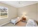 This bedroom features two twin beds, neutral walls, and a ceiling fan at 357 Marsh Creek Rd, Venice, FL 34292
