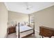 Inviting bedroom featuring a four-poster bed, soft lighting, and natural light from a window at 357 Marsh Creek Rd, Venice, FL 34292