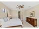 Bright bedroom with four-poster bed, neutral walls, and natural light from two windows at 357 Marsh Creek Rd, Venice, FL 34292