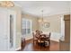 Charming dining room features hardwood floors, wainscoting, and a chandelier, creating a sophisticated and inviting atmosphere at 357 Marsh Creek Rd, Venice, FL 34292