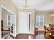 Inviting foyer with hardwood floors, natural light, and a view into the dining room and office creates a warm welcome at 357 Marsh Creek Rd, Venice, FL 34292