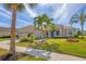 Beautiful single-Gathering home with mature palms, manicured lawn and a beige exterior at 357 Marsh Creek Rd, Venice, FL 34292