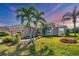 Lovely single-Gathering home with mature palms, manicured lawn, and neutral exterior at 357 Marsh Creek Rd, Venice, FL 34292