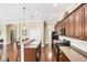 Spacious open kitchen with a large island, breakfast bar, hardwood floors, and stainless steel appliances provides ample space at 357 Marsh Creek Rd, Venice, FL 34292