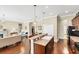 Open kitchen with a long breakfast bar, wood floors, and black appliances provides ample space for cooking and entertaining at 357 Marsh Creek Rd, Venice, FL 34292