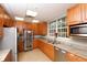 Community kitchen featuring stainless steel appliances, granite countertops, and ample cabinet space at 357 Marsh Creek Rd, Venice, FL 34292