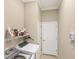 This laundry room features a washer, dryer and storage shelving at 357 Marsh Creek Rd, Venice, FL 34292