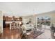 Bright open-concept living space with hardwood floors, views of the pool, and dining area at 357 Marsh Creek Rd, Venice, FL 34292