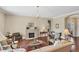 Spacious living room boasts a fireplace, hardwood floors, neutral walls, and an abundance of natural light at 357 Marsh Creek Rd, Venice, FL 34292