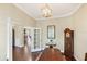 Versatile office space with hardwood floors, glass door entry, and views into the dining room offers flexibility and style at 357 Marsh Creek Rd, Venice, FL 34292
