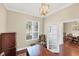 Home office space with a large desk, natural light, and hardwood floors provides a comfortable and productive work environment at 357 Marsh Creek Rd, Venice, FL 34292