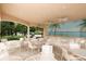 Covered patio with ceiling fans, mural, and plenty of seating for outdoor enjoyment at 357 Marsh Creek Rd, Venice, FL 34292