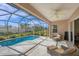 A screened-in pool and patio area with outdoor seating that is ideal for entertaining at 357 Marsh Creek Rd, Venice, FL 34292