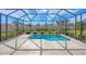 Screened-in pool and patio area with lush landscaping, perfect for relaxing and enjoying the outdoors at 357 Marsh Creek Rd, Venice, FL 34292