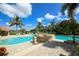 Community pool with palm trees and plenty of lounge chairs for relaxing poolside at 357 Marsh Creek Rd, Venice, FL 34292