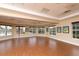 Spacious recreation room with wood floors and ample natural light through many windows at 357 Marsh Creek Rd, Venice, FL 34292