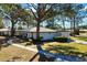 House with a curved walkway, driveway, and surrounding trees at 407 Degas Dr, Nokomis, FL 34275