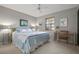 Calm bedroom with a king-size bed and a workspace at 407 Degas Dr, Nokomis, FL 34275