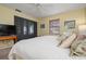 Bright bedroom featuring a king-size bed and a flat-screen TV at 407 Degas Dr, Nokomis, FL 34275