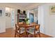 Dining room with mid century modern table and chairs, wood floors and access to a patio at 407 Degas Dr, Nokomis, FL 34275