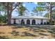 Front view of a single-story home with a tiled roof and lush landscaping at 407 Degas Dr, Nokomis, FL 34275