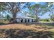 White single story home with arched entry and mature landscaping at 407 Degas Dr, Nokomis, FL 34275