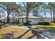 Charming single story home with tile roof, lush landscaping, and a paved walkway at 407 Degas Dr, Nokomis, FL 34275