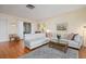 Living room with white sectional sofa, wood floors, and mid century modern decor at 407 Degas Dr, Nokomis, FL 34275