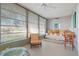 Sunroom with daybed, seating, and large windows at 407 Degas Dr, Nokomis, FL 34275