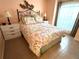 Bedroom with a floral comforter, nightstands, and ample natural light at 4091 Pomeroy St, North Port, FL 34291