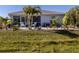Relaxing backyard oasis featuring a patio and lush tropical landscaping at 4251 Oak Terrace Cir, Port Charlotte, FL 33953