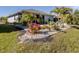 Spacious backyard with patio, tropical landscaping, and screened enclosure at 4251 Oak Terrace Cir, Port Charlotte, FL 33953