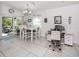 Bright dining area with white table and access to patio at 4251 Oak Terrace Cir, Port Charlotte, FL 33953