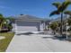 Gray house with attached garage and landscaped yard at 4251 Oak Terrace Cir, Port Charlotte, FL 33953