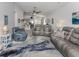 Bright living room with gray couches and view into kitchen at 4251 Oak Terrace Cir, Port Charlotte, FL 33953