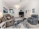 Living room with gray couches, large TV, and area rug at 4251 Oak Terrace Cir, Port Charlotte, FL 33953