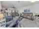 Spacious living room with gray couches and large area rug at 4251 Oak Terrace Cir, Port Charlotte, FL 33953