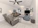 Open living room with gray couches and access to kitchen at 4251 Oak Terrace Cir, Port Charlotte, FL 33953