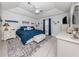 Spacious main bedroom with a ceiling fan and blue bedding at 4251 Oak Terrace Cir, Port Charlotte, FL 33953