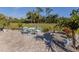 Relaxing patio with seating area, surrounded by tropical plants at 4251 Oak Terrace Cir, Port Charlotte, FL 33953